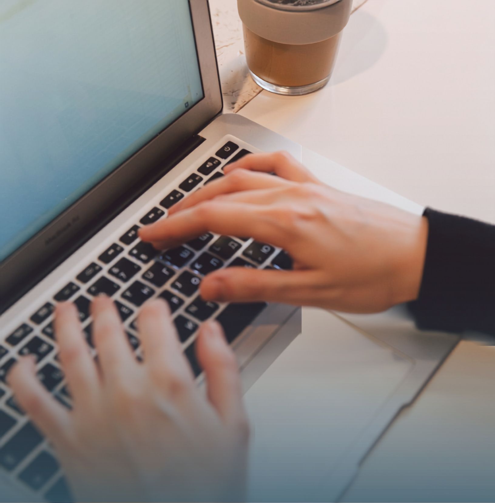 A person is typing on a laptop