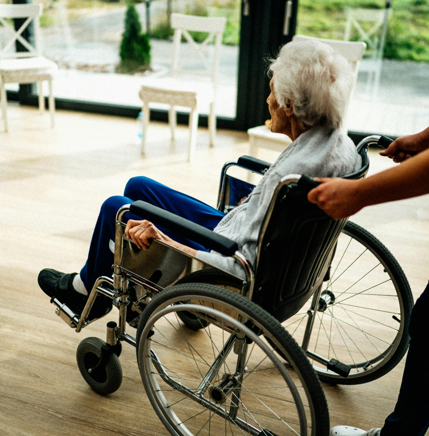 Assist an elder woman on a wheel chair
